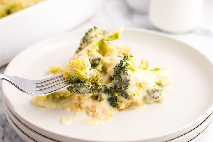 cheesy broccoli au gratin recipe, Cheesy Broccoli Au Gratin on a white plate with a fork