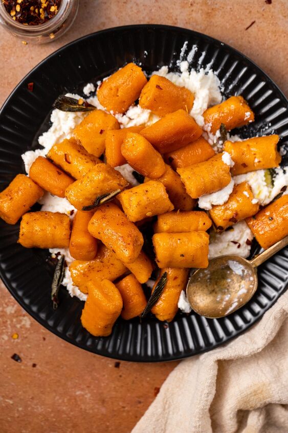 sweet potato gnocchi in a brown butter sage sauce, Served over ricotta and garnished with red pepper flakes this dish is simple yet delicious