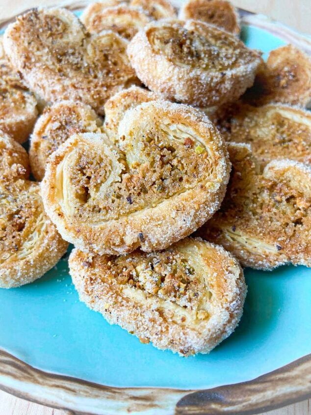 pistachio palmiers with cardamom, A close up of pistachio palmiers on a plate