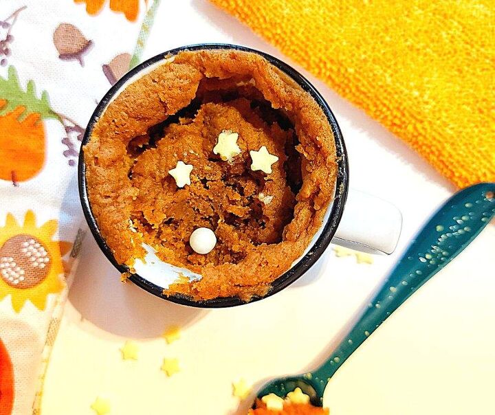 pumpkin spice mug cake that fall dreams are made of, pumpkin mug cake with a spoonful taken out