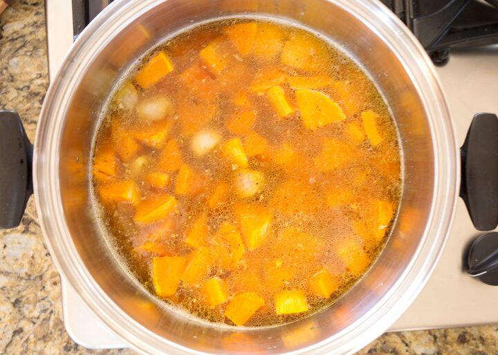 roasted butternut squash soup, Squash and broth added to the pot with ginger and garlic