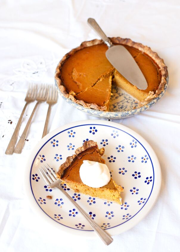 real food pumpkin pie, Slice of pumpkin pie on a plate with vintage forks and the whole pie in the background