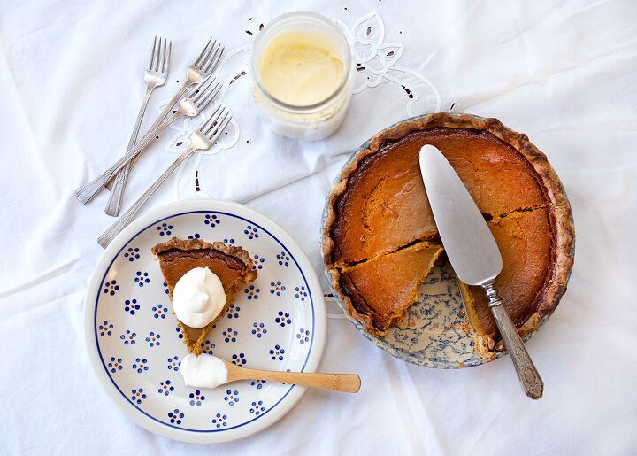 real food pumpkin pie, A piece of pumpkin pie on a plate with cream and the pie plate beside