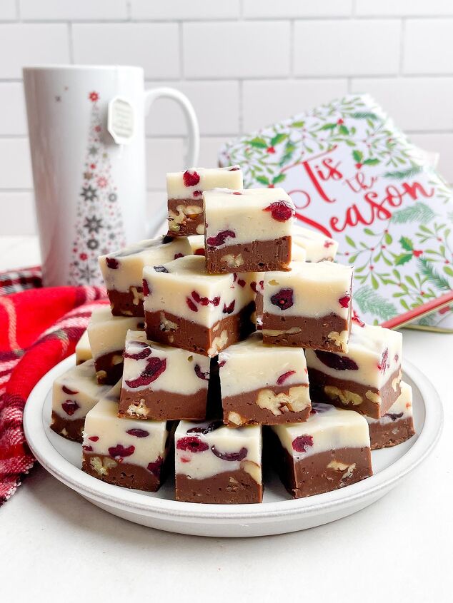 cranberry pecan christmas fudge recipe, squares of Christmas fudge on a white plate