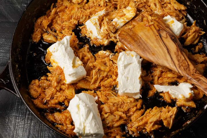 easy buffalo chicken dip recipe, Cream cheese added to chicken in a skillet