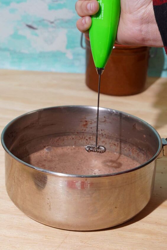 hot chocolate recipe without milk, person holding milk frother over pan of oat milk hot chocolate