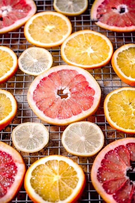 how to dehydrate orange slices in the oven or air fryer, thinly sliced citrus on a baking sheet