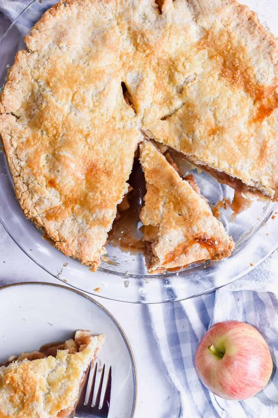 the best homemade apple pie, A piece of apple pie is cut out of the larger pie