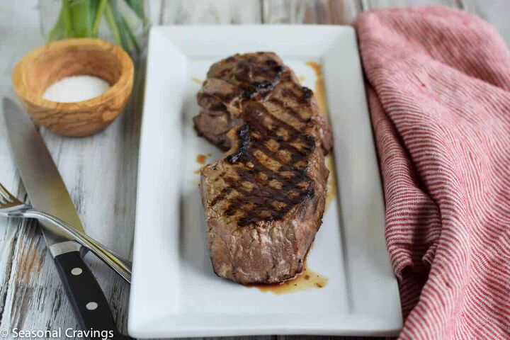 tender london broil, Tender London Broil recipe on a white plate with knife