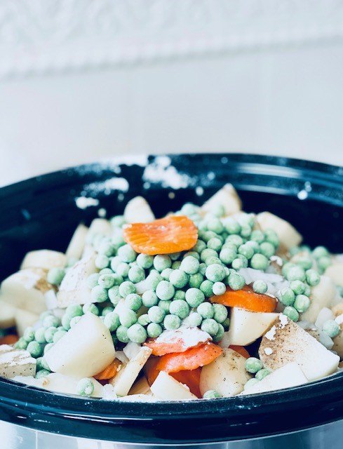 the best crock pot gluten free beef stew, Potatoes carrots and peas in the crock pot