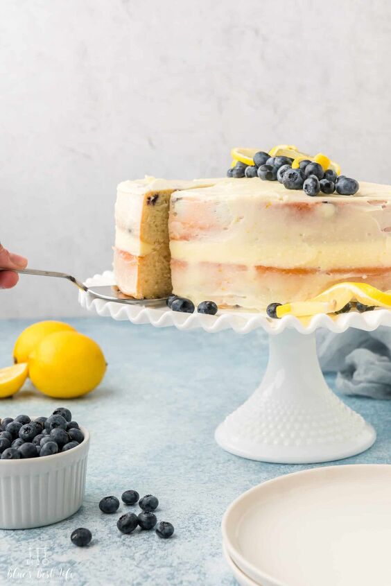lemon berry mascarpone cake with lemon buttercream frosting, The lemon berry cake on a white cake stand