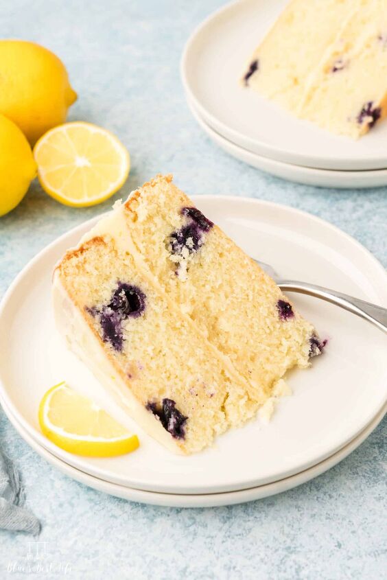 lemon berry mascarpone cake with lemon buttercream frosting, A slice of blueberry lemon cake
