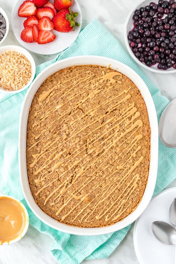 healthy baked oatmeal with peanut butter, Healthy baked oatmeal in baking dish drizzled with peanut butter