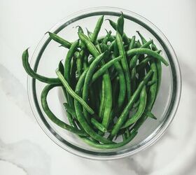 how to make green bean casserole with fresh green beans, green beans in a bowl with water