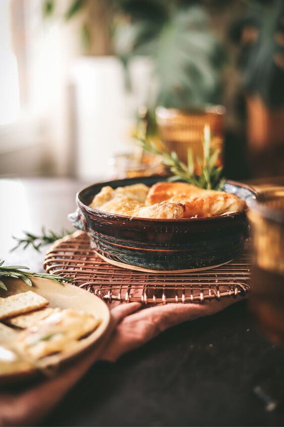 easy baked brie with fig jam and rosemary, Baked brie in a ceramic bowl with fig jam