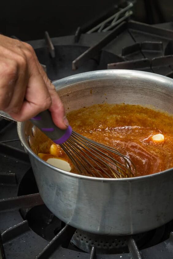 close up of a whisk mixing fresh home made caramel in a sauce pan