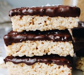 chocolate covered rice krispie treats, sideview chocolate covered rice krispie treats stacked on parchment paper