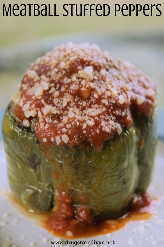 Sauce and cheese on top of a cooked green pepper with the words Meatball Stuffed Peppers digitally written on top