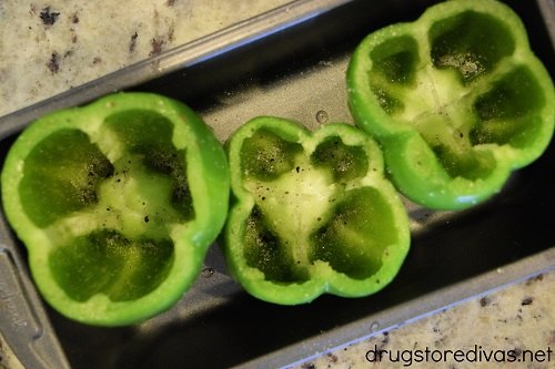 Three cut green peppers in a bread tin