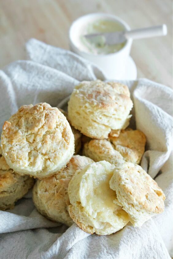 easy and quick biscuit recipe, biscuits in a towel lined basket with butter on the side