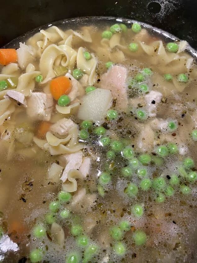classic chicken noodle soup with a twist, classic chicken noodle soup simmering in the stock pot