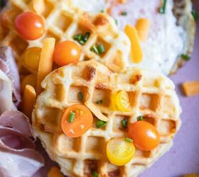 savory buttermilk cheddar belgian waffles, heart shaped waffles topped with tomatoes and chives set on a pink plate