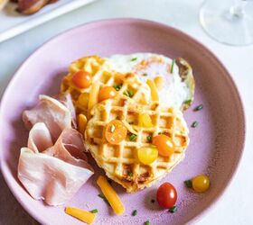 savory buttermilk cheddar belgian waffles, Buttermilk Belgian Waffles on a pink plate topped with tomatoes cheese and egg