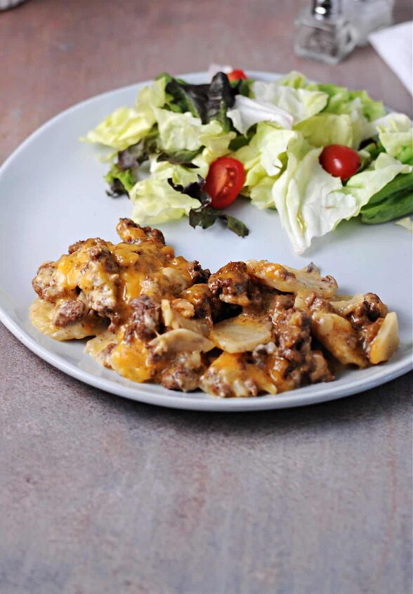 hamburger and potato casserole, hamburger potato casserole on a plate with green salad