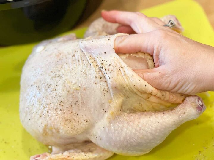 slow cooker orange chicken, stretching the skin on the chicken to place herbs and butter underneath