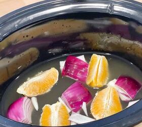 slow cooker orange chicken, orange sections onion quarters and chicken broth in crock pot