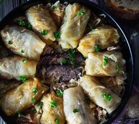 classic bosnian stuffed cabbage rolls sarma, An overhead photo of cabbage rolls placed in a circle in a round dish with smoked meat in the middle