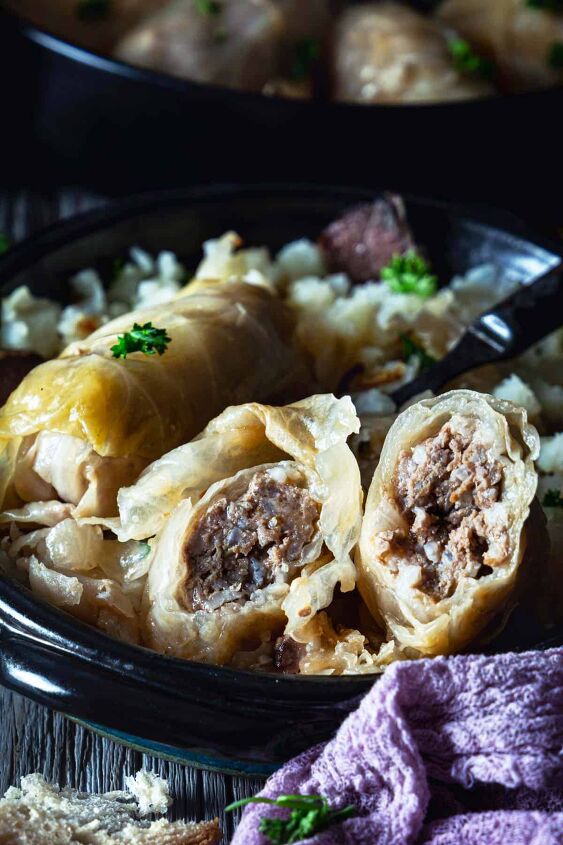 classic bosnian stuffed cabbage rolls sarma, A close up of the cabbage roll cut in half showing the ground beef filling inside