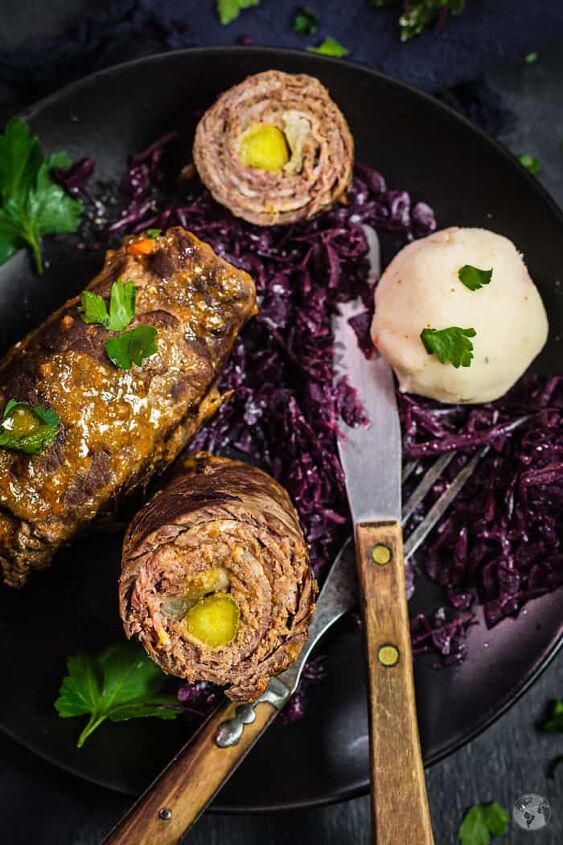 rouladen german beef roll ups instant pot and slow cooker, A close up shot of rouladen on a plate with rotkohl and a fork and knife