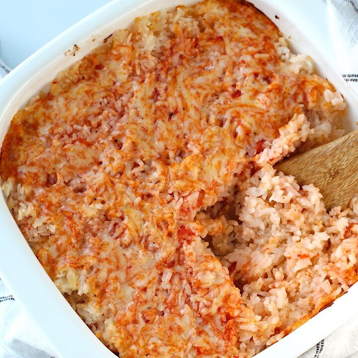 brazilian baked rice with cheese and tomatoes, Spatula scooping Baked Rice with Cheese and Tomatoes up from casserole dish