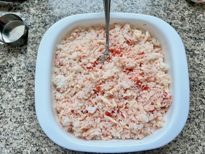 brazilian baked rice with cheese and tomatoes, Cooked rice tomatoes and cheese mixed together in a casserole dish for Baked Rice with Cheese and Tomatoes