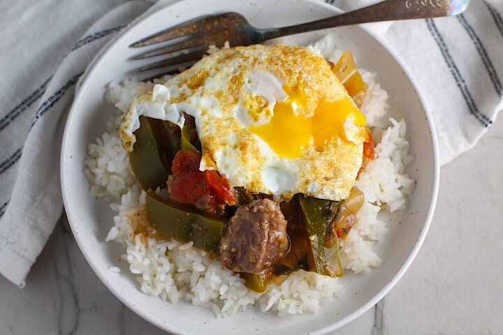 beef stew stove top picadinho with beef cubes, Fried egg on top of cooked Brazilian Beef Stew Stove Top recipe over rice in bowl with fork in it on counter It s a savory succulent and hearty dish that you can make anytime