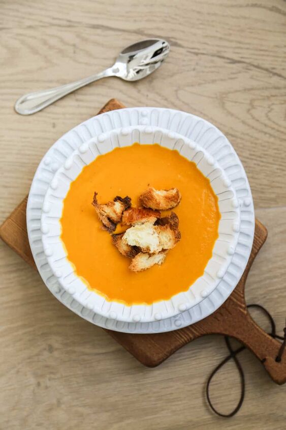 creamy pumpkin and sweet potato soup gluten free vegan, bowl of sweet potato and pumpkin soup with brioche croutons
