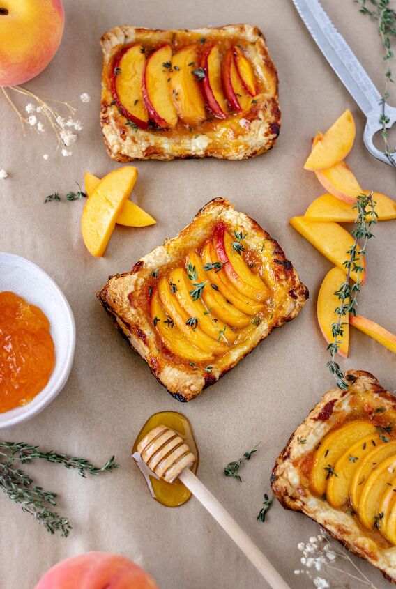 easy peach apricot tarts dairy free, Mini peach tarts on parchment paper surrounded by peach slices fresh thyme and apricot preserves