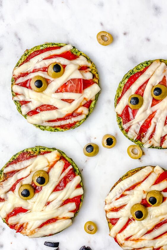 healthy halloween mummy pizzas gluten free, Halloween Mummy Pizzas is the perfect Halloween party or dinner idea Make these mummies with your kids for an easy and super flavorful Halloween themed meal These mini pizzas are also gluten free The Yummy Bowl savouryhalloweenfood halloweenfoodrecipes halloweenmummypizza mummypizza creepyhalloweenfoodideas traditionalhalloweenfood halloweentreats