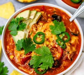 crock pot chicken enchilada, chicken enchilada in a bowl with avocado jalapeno tortilla chips on a gray background