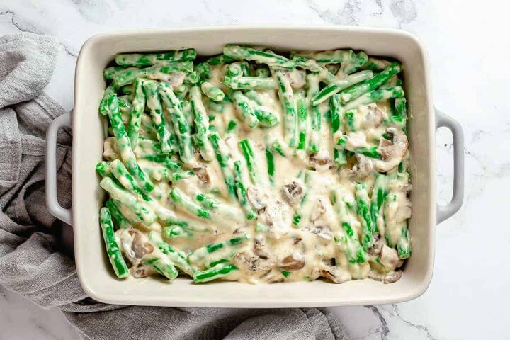 cheesy green bean casserole with bacon, Creamy mushroom sauce with green beans in baking dish