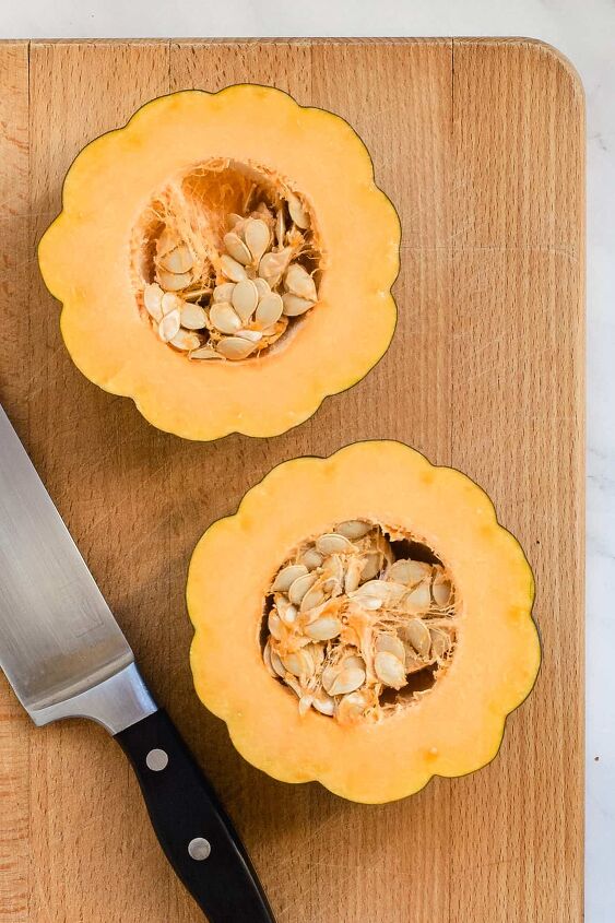 air fryer acorn squash slices, Acorn squash halves on a wooden cutting board with knife