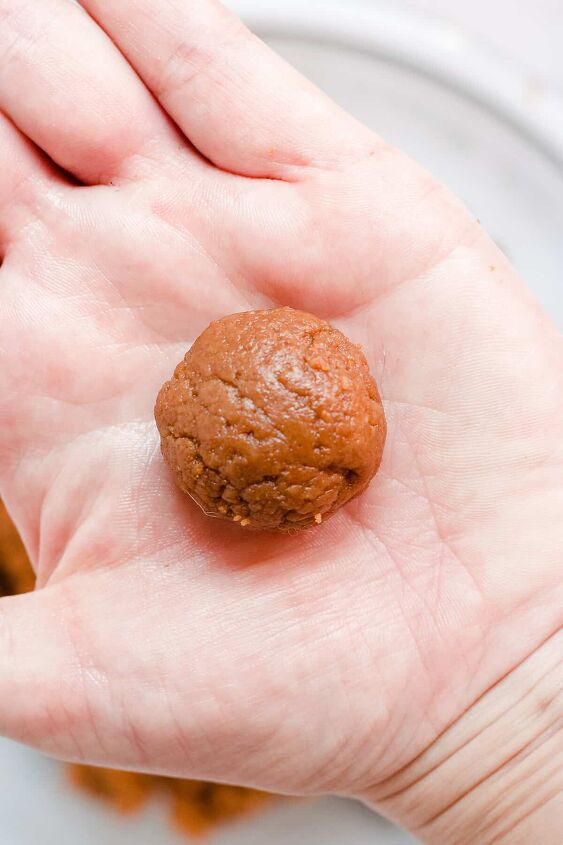 biscoff cookie truffles, Hand holding a rolled truffle