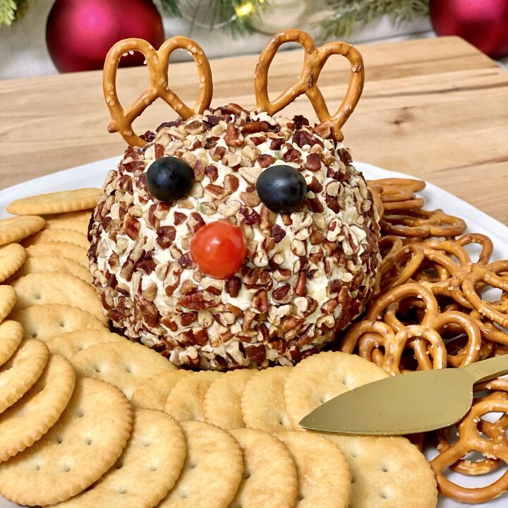 rudolph christmas cheese ball, Rudolph Christmas Cheese Ball With crackers pretzels and a gold spreader with it on the plate
