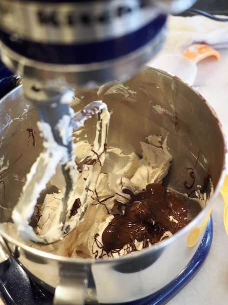 adding chocolate to egg mixture for Mini Chocolate French Silk Pies