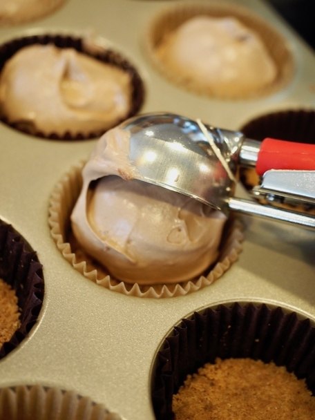 scooping the french silk mixture into muffin tins for Mini Chocolate French Silk Pies