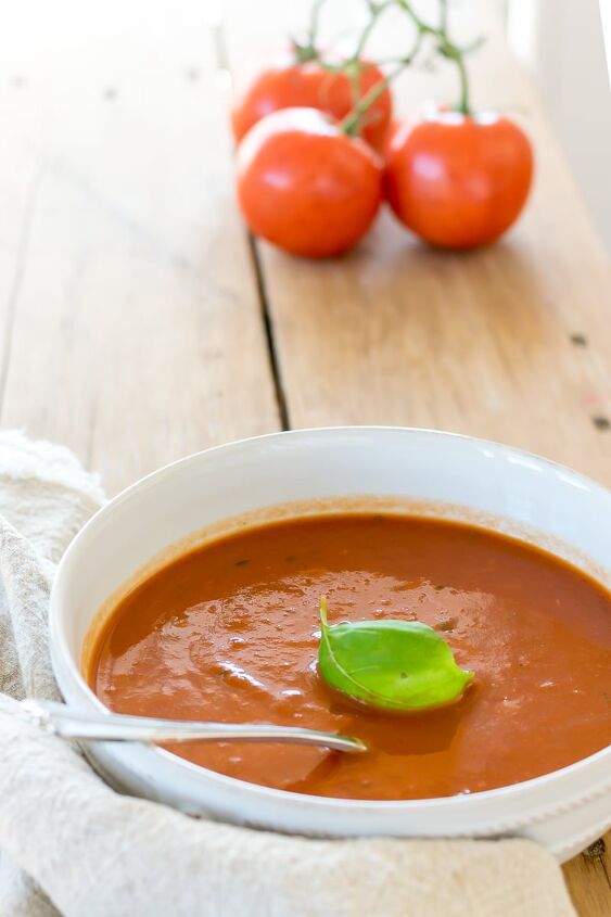healthy homemade tomato soup very low fat, Healthy Homemade Tomato Soup in white bowl with fresh tomatoes in the background