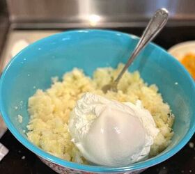 easy twice baked mashed potato casserole recipe, Easy Twice Baked Mashed Potato Casserole process photo with cooked potatoes in a bowl with sour cream added but not yet mixed in