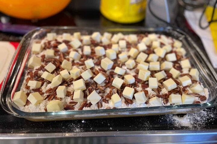 pumpkin crunch cake with yellow cake mix, Pumpkin crunch recipe process picture with assembled crunch ready to go in oven with butter cubes on top