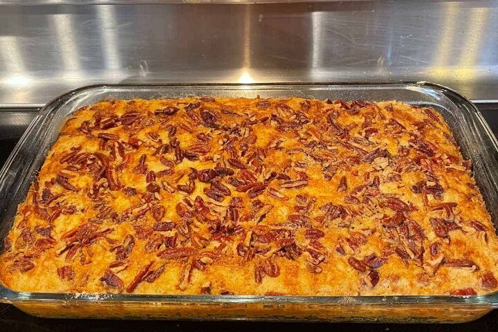 pumpkin crunch cake with yellow cake mix, baked pumpkin crunch out of the oven in a baking dish cooling off